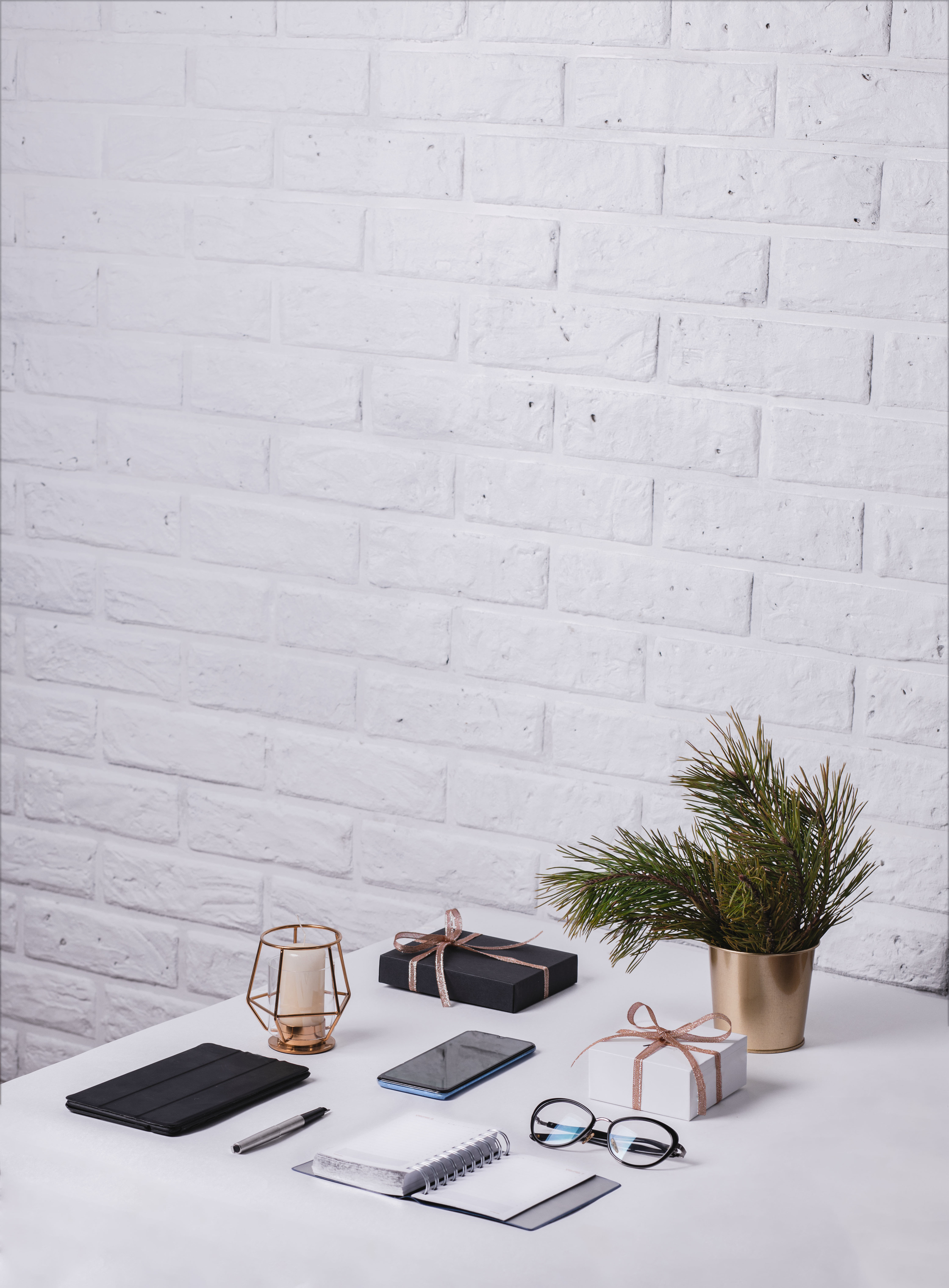 Office Work Accessories on Desk with White Brick Background